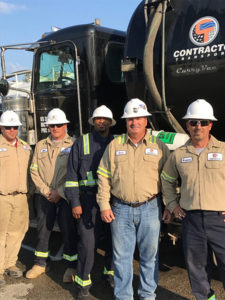 Contractor Transport team in front of a company truck